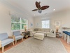 Relax in your bright living room with plush seating, tropical ceiling fan, and plenty of natural light. Unwind after beach adventures in this coastal-inspired retreat.