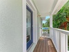 Covered entrance with charming coastal details and lush tropical greenery welcoming you to the property.