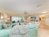 Settle into your spacious beachfront living room where soft aqua furnishings and ocean breezes create your perfect coastal escape. Floor-to-ceiling windows frame stunning sea views, inviting you to relax and unwind.