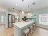 Gather around this bright, coastal-inspired kitchen where your meals take center stage. The spacious island invites conversation while soft aqua tones and marble counters create a refreshing, beachy vibe.