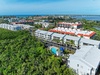 Coastal resort property nestled among lush tropical vegetation with pool facilities and nearby waterfront access in this scenic island setting.