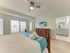 Wake up refreshed in this serene coastal bedroom. Soft sea breeze from the ceiling fan, crisp linens, and your own ensuite bathroom await. Natural light fills the space as you start your perfect beach day.