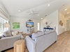 Sink into plush sofas and unwind in your bright coastal living room, where natural light, nautical touches, and a cozy reading lamp invite you to relax in style.