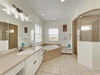 Your spacious en-suite bathroom features dual vanities, a deep soaking tub, and a separate walk-in shower—perfect for unwinding after a day of adventure.