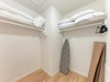 Your walk-in closet offers ample storage with built-in shelving, hanging rods, and extra linens for your comfort.