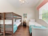 Sleep soundly in this bright bedroom with a cozy bunk bed and twin bed—perfect for families or friends traveling together. Crisp linens and coastal accents add a welcoming touch.