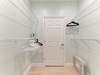 Your walk-in closet features abundant hanging space, built-in shelving, and a convenient ironing board—perfect for keeping your wardrobe organized and wrinkle-free during your stay.