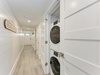 Your in-unit washer and dryer make packing light a breeze, tucked neatly into this bright hallway for your convenience.