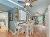 Settle into your charming coastal retreat featuring a cozy dining nook and relaxing living space, all bathed in soothing ocean-inspired hues that invite you to unwind.
