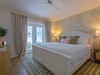 Your tropical-inspired bedroom features a plush king bed with coastal accents, tropical wallpaper, and soft lighting to help you unwind after a day of exploring.