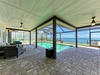 Relax in your private covered pool area with stunning ocean views, featuring comfortable seating and direct beach access for unforgettable coastal moments.