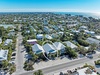 Aerial view of coastal neighborhood showing the property's prime location among tropical homes near pristine beaches.
