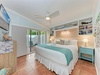 Drift off to sleep in your coastal bedroom with built-in shelves, ceiling fan, and private patio access for morning coffee.