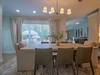 Gather around this inviting dining table where you'll share meals and memories under soft chandelier light. Large windows fill your space with natural warmth, creating the perfect setting for your vacation moments together.