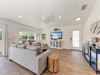 Sink into plush seating and let coastal breezes flow through your sun-filled retreat, where beach-inspired decor and natural wood accents create your perfect vacation haven.