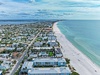 Stunning coastal community with pristine sandy beaches and turquoise waters stretching along the shoreline.