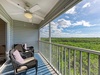 Relax in your private screened balcony with comfortable seating and sweeping forest views stretching to the horizon.