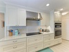 Your dream kitchen awaits with elegant white cabinetry, gleaming granite counters, and top-tier stainless steel appliances. Warm recessed lighting and stylish backsplash create the perfect space for your culinary adventures.