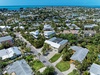 Tropical residential neighborhood near turquoise waters, featuring lush palm trees and modern homes just steps from paradise.