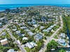 Aerial view of a coastal island community with residential properties, showing the location of your rental among charming island homes.