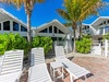 Modern beachside villa with tropical landscaping and sun loungers for the ultimate Florida Keys getaway.