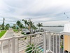 This waterfront property features palm-lined streets, private docks, and sweeping bay views—a picturesque coastal neighborhood setting.
