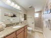 Refresh in your granite-topped bathroom featuring a spacious walk-in shower and plush towels.