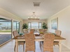 Gather around this inviting dining table where coastal breezes and stunning waterfront views create the perfect backdrop for your meals together.