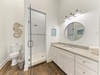 Your coastal-inspired bathroom features a spacious walk-in shower, generous vanity with granite counter, and beach-themed décor—perfect for refreshing after sunny days exploring.