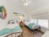 Drift off in this cheerful coastal bedroom with twin beds and playful nautical décor. Crisp linens and beachy touches make your stay feel like a seaside escape.
