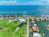 Stunning coastal retreat nestled between waterways and oceanfront, offering access to lush golf greens and private boat docks in a tranquil island community.