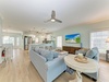 Sink into the plush sectional and unwind in this airy, open-concept living space with soft coastal hues, natural light, and your favorite shows on the big screen.