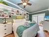 Your coastal retreat awaits with a plush bed, crisp linens, and thoughtful touches like rolled towels. Built-in shelves, a ceiling fan, and TV create a relaxing, personalized escape.