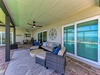 Relax in your covered patio with wicker seating, ceiling fans, and stylish accents—perfect for unwinding while enjoying views of the surrounding area.