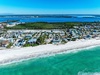 Stunning beachfront location with crystal-clear turquoise waters and pristine white sand stretching along this coastal community.