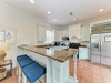 Your fully equipped kitchen features granite countertops, modern appliances, and a spacious island with bar seating—perfect for cooking and gathering together.
