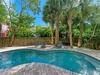 Private pool oasis surrounded by tropical palms and comfortable lounge chairs for your perfect Florida getaway.