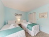 Drift off in your peaceful twin bedroom with fresh linens and coastal charm perfect for relaxation.