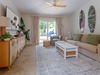 Unwind in your bright, coastal-inspired living room with tropical decor and garden views. Relax on plush seating or step outside to your private patio.