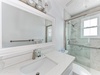 Refresh in your elegant marble bathroom, featuring a luxurious soaking tub and spacious glass shower with modern fixtures.