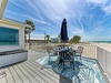 Beachfront deck with dining table where you'll savor meals while listening to ocean waves and feeling Gulf breezes.