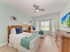 Unwind in your coastal retreat with twin beds dressed in crisp linens, soothing sea-glass walls, and gentle ceiling fan breezes to lull you to sleep.