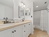 The primary bathroom has dual vanities