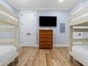 The bunk room features two twin over twin bunks and a flat-screen TV