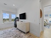 Second floor guest bedroom 4 features arcade games and a mounted flat-screen TV