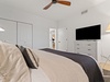 The guest bedroom has a flat-screen TV