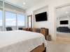 Master bedroom with large flat-screen TV