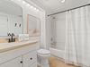 The guest bathroom has a shower/tub combo