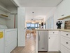 There is a standalone icemaker in the kitchen