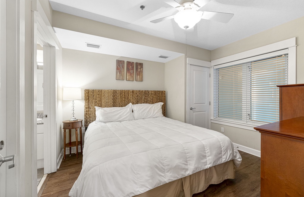 Cozy bedroom with a woven headboard and natural light from the window
